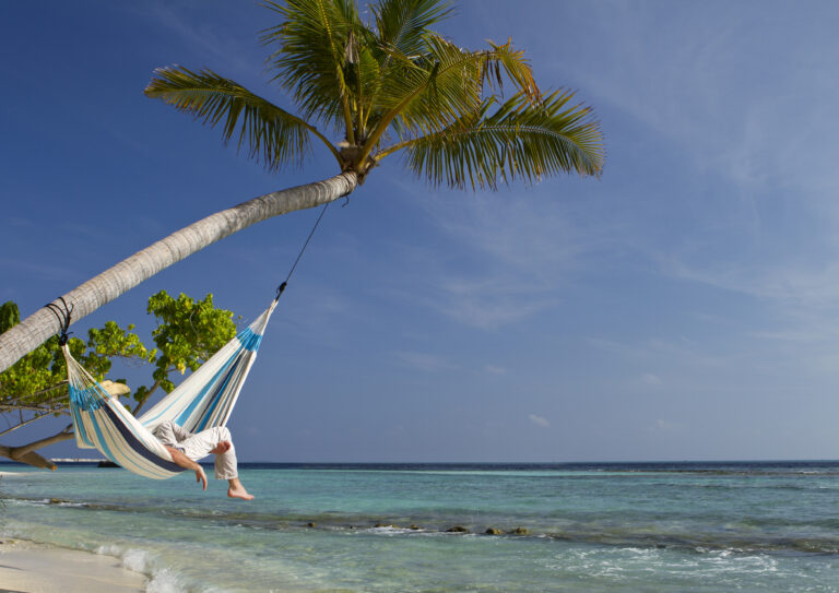 Person in hammock at a beach