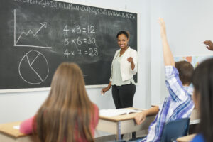 Black female teacher at chalkboard