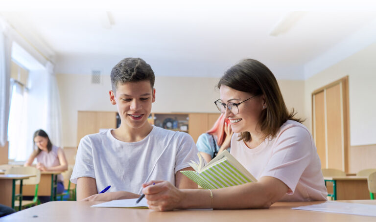 Teacher helping student read