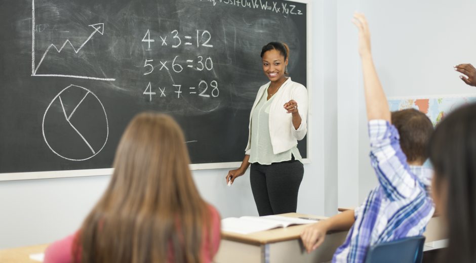 Black female teacher at chalkboard